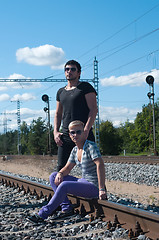 Image showing Two young attractive guy on rails