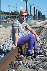 Image showing Attractive young guy on rails