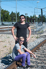 Image showing Two attractive young guys on rails