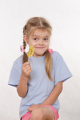 Image showing Portrait of five year girl with lollipop in her hand