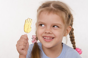 Image showing Five year old girl looking for fun candy