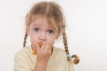 Image showing Three year old girl bun chews