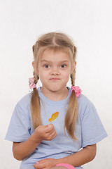 Image showing Cheerful five year girl with sweet candy in hands of