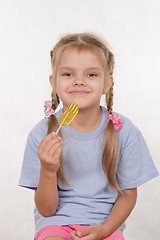 Image showing Cheerful five year old girl with a lollipop