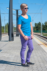 Image showing Stylish man  in blue standing on train station