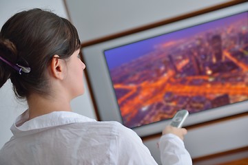 Image showing young woman watching tv at home