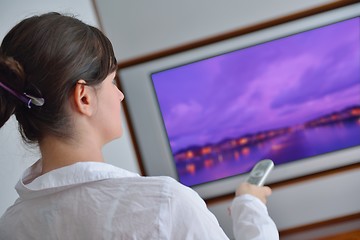 Image showing young woman watching tv at home