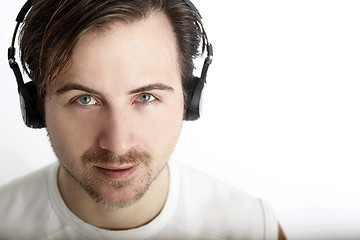 Image showing Attractive man with headphones looks into the camera