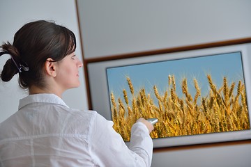 Image showing young woman watching tv at home