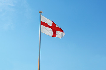 Image showing The English flag flies against a blue sky