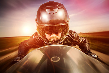 Image showing Biker racing on the road