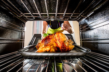 Image showing Cooking chicken in the oven at home.