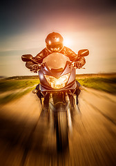 Image showing Biker racing on the road