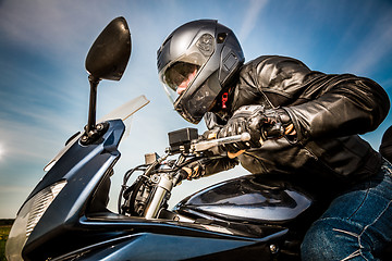 Image showing Biker racing on the road