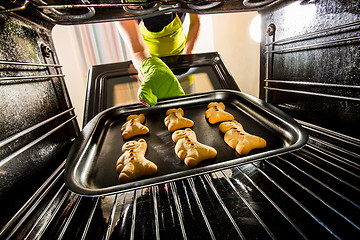 Image showing Baking Gingerbread man in the oven