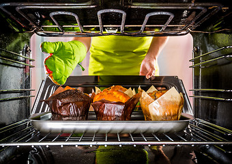 Image showing Baking muffins in the oven