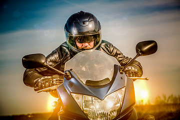 Image showing Biker racing on the road