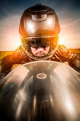 Image showing Biker racing on the road