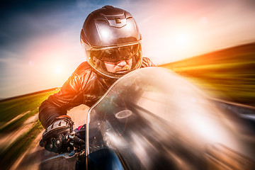 Image showing Biker racing on the road