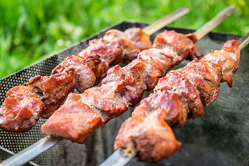 Image showing Hot shish kebab on metal skewers