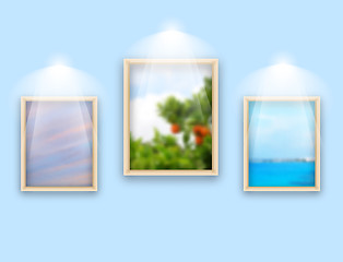 Image showing Three frames with photos hanging on wall