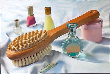 Image showing Massage brush and conditioning agents behind a body.