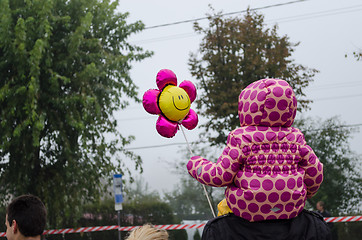 Image showing girl with pink dotted jacket sit on dad shoulders 