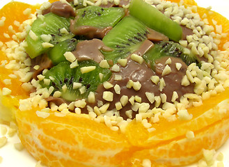 Image showing Chocolate pudding with kiwi fruit, orange and little pieces of a