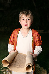 Image showing Boy reading a scroll