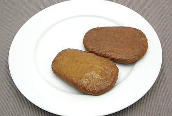 Image showing Two breaded bean curd cutlets on a white plate