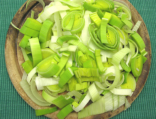 Image showing SLiced green leek on a wooden plate