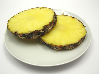 Image showing Two slices of pineapple on a white plate