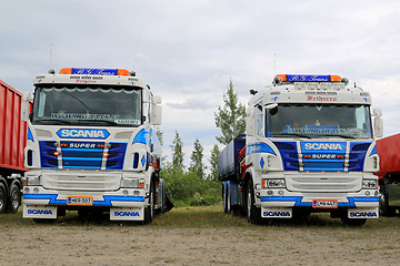 Image showing Two Colorful Scania Tipper Trucks in a Show