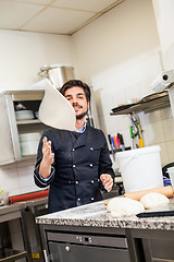 Image showing Chef tossing dough while making pastries