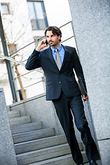 Image showing Businessman listening to a call on his mobile