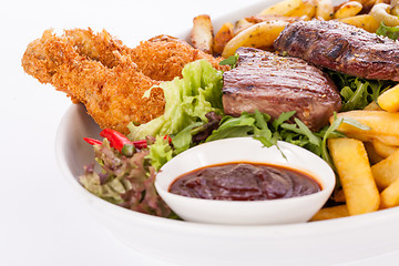 Image showing Platter of mixed meats, salad and French fries