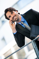 Image showing Businessman listening to a call on his mobile