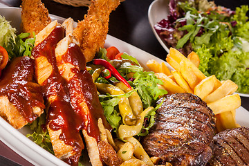 Image showing Platter of mixed meats, salad and French fries