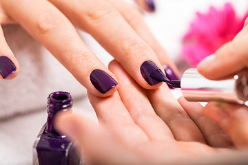 Image showing Woman having a nail manicure in a beauty salon