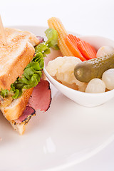 Image showing Delicious pastrami club sandwich and pickles