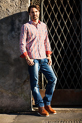 Image showing Male model leaning against wall