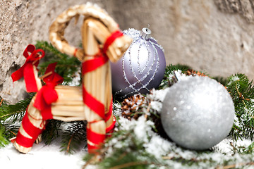 Image showing Silver Christmas bauble on a tree with snow