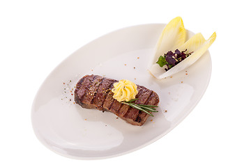 Image showing Grilled beef steak topped with butter and rosemary