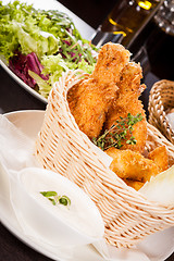 Image showing Crisp crunchy golden chicken legs and wings