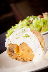 Image showing Baked jacket potato with sour cream sauce