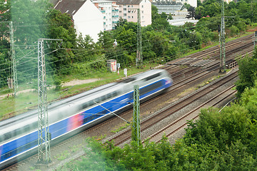 Image showing Fast moving train with red stripe