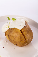 Image showing Baked jacket potato with sour cream sauce