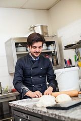 Image showing Chef tossing dough while making pastries