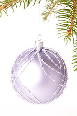 Image showing Christmas ball hanging from a branch of a fir tree