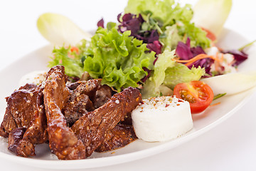 Image showing grilled beef stripes fresh salad and goat cheese